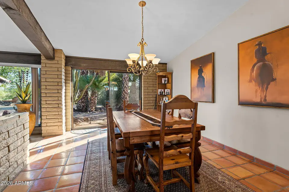 Dining area with chandelier and sliding doors to the garden