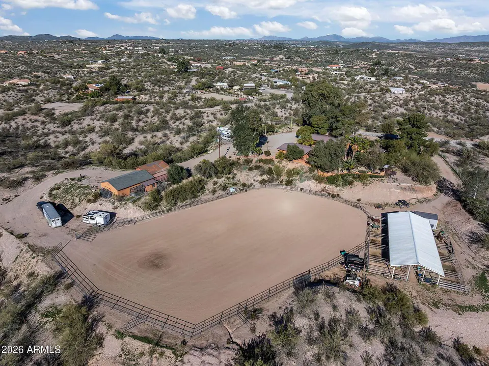 Wide aerial of the arena, outbuildings, and surrounding desert