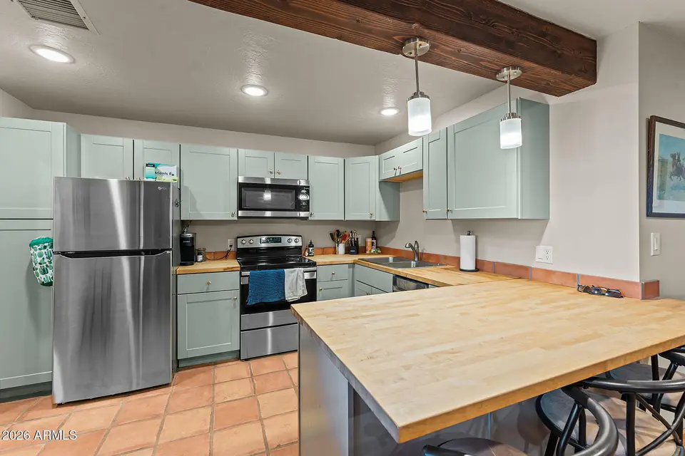 Casita kitchen with butcher-block peninsula and stainless appliances