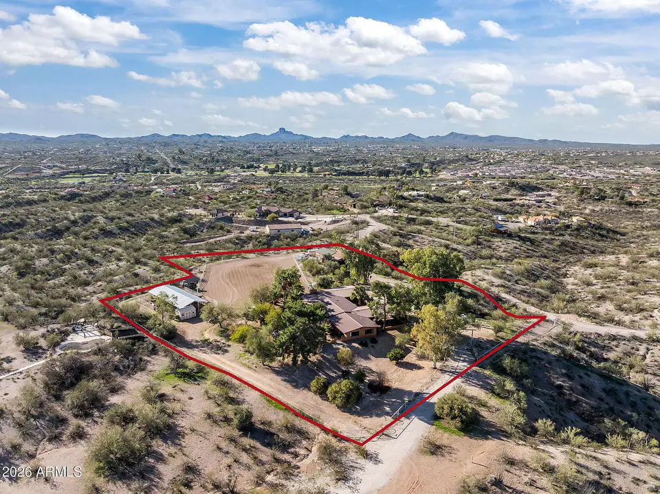 Aerial photo of the 3.47-acre property with its boundary outlined in red